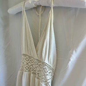 Beautiful long white beach dress with lace detail, halter top, and low tie back